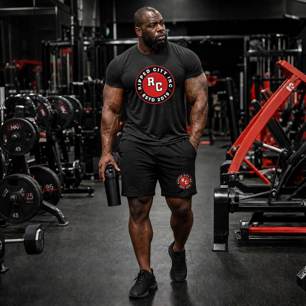 Men's black performance shorts with RC badge, worn by athletic model in gym