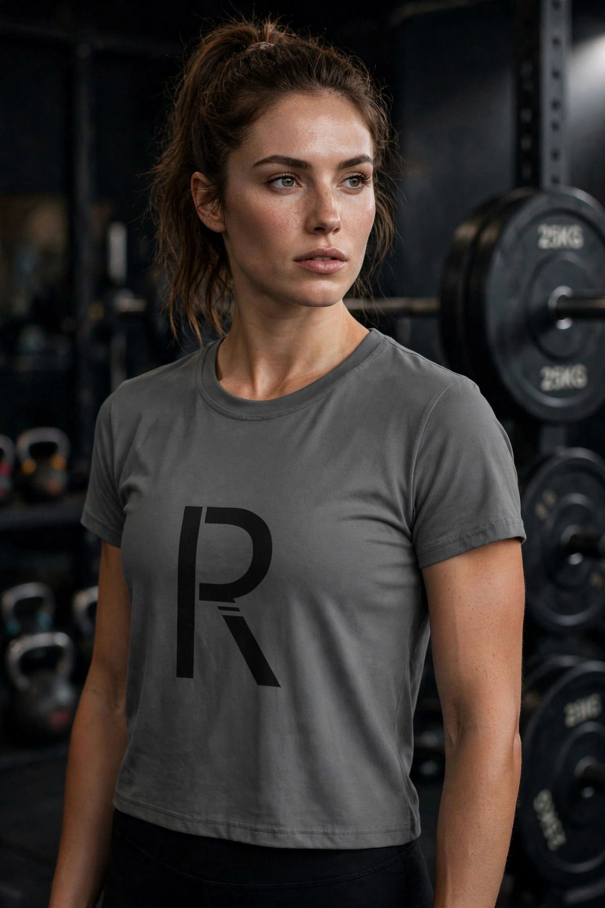 Athletic model in a gray Ripped City tee with large black R centered, gym scene