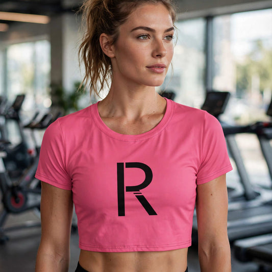 Athletic model in a pink Ripped City tee with large black R centered, gym scene