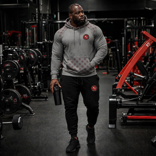 Unisex grey training hoodie with RC badge, worn by athletic model in gym