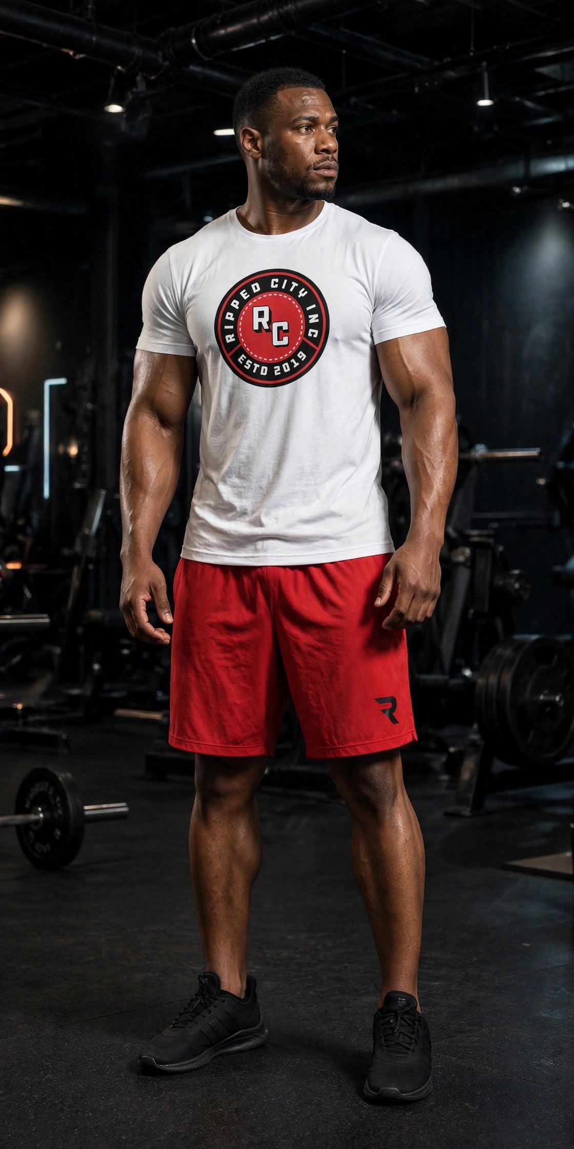 Athletic model in red Ripped City gym shorts with R logo on the leg, gym scene