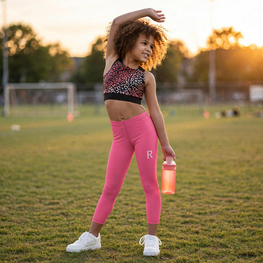 Young athlete in a pink Ripped City girls' set with R logo, gym setting