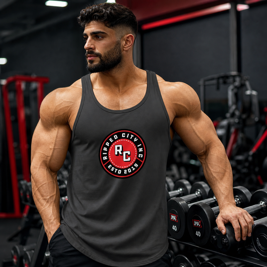 Muscular athlete wearing the Ripped City men's charcoal muscle tank top in a gym - Ripped City Inc premium gym apparel