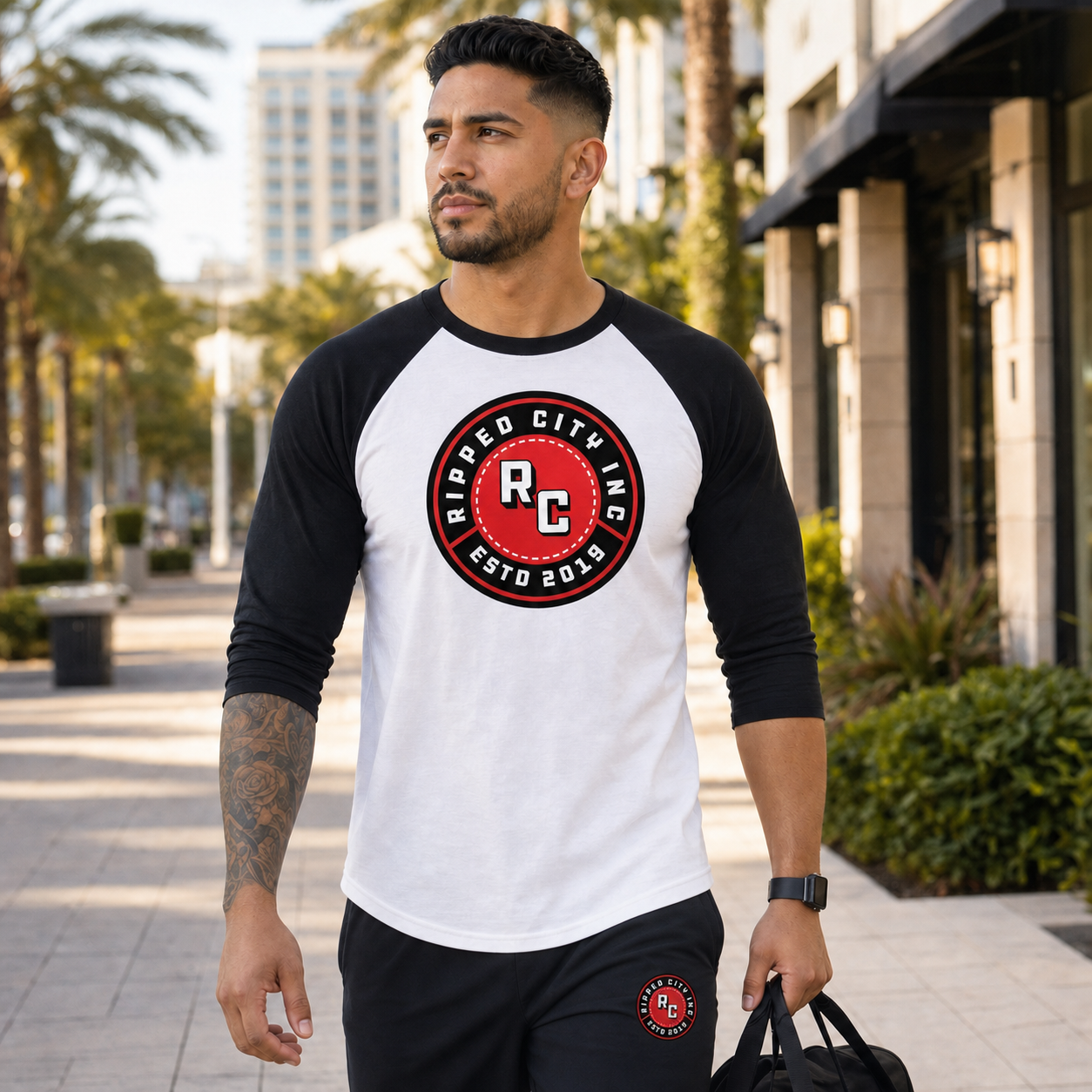 Athletic man wearing a coordinated Ripped City raglan shirt and jogger outfit - Ripped City Inc premium gym apparel